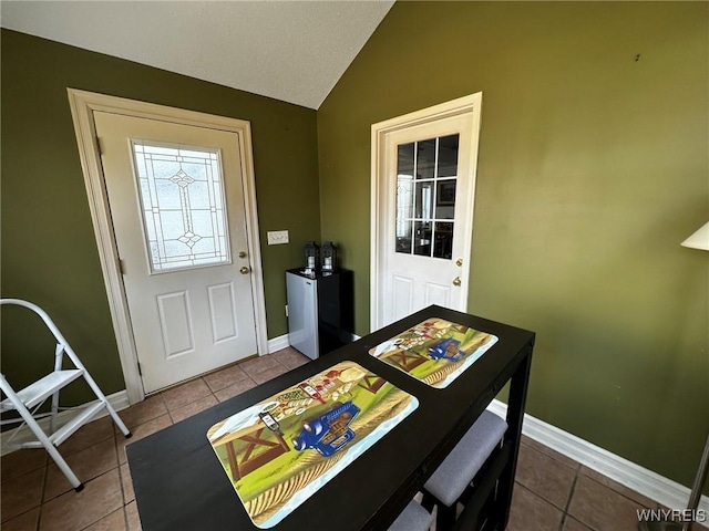 interior space featuring baseboards and lofted ceiling