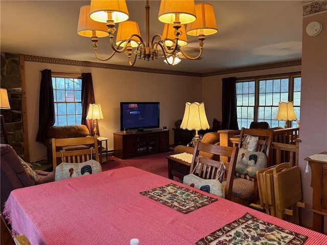 dining area featuring crown molding, a notable chandelier, carpet, and plenty of natural light