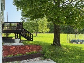 215 Kautz Rd, Delaware, NY 12723 - view of green lawn with stairway and a wooden deck