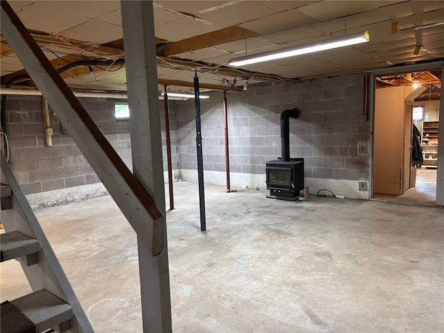215 Kautz Rd, Delaware, NY 12723 - unfinished basement featuring stairway, a wood stove, and concrete block wall