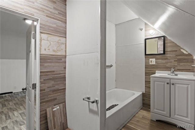 full bathroom featuring wood finished floors, vanity, and tile walls