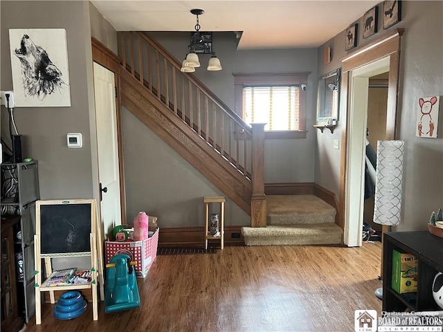 9 Columbia Ave, Ellicott, NY 14701 - staircase with baseboards and wood finished floors