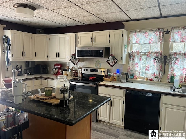 9 Columbia Ave, Ellicott, NY 14701 - kitchen featuring light wood-style floors, white cabinets, and stainless steel appliances