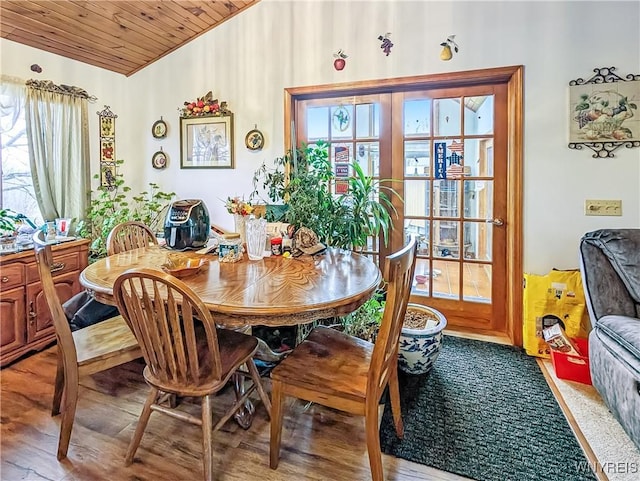 dining room with a healthy amount of sunlight, wood ceiling, french doors, and lofted ceiling