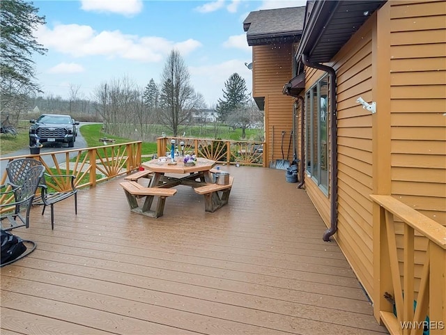 wooden terrace with outdoor dining area