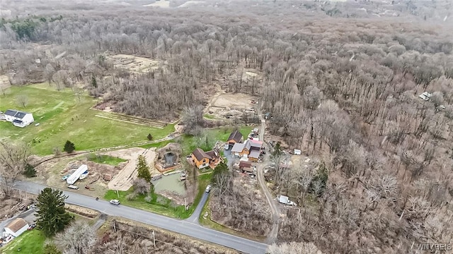 birds eye view of property with a view of trees
