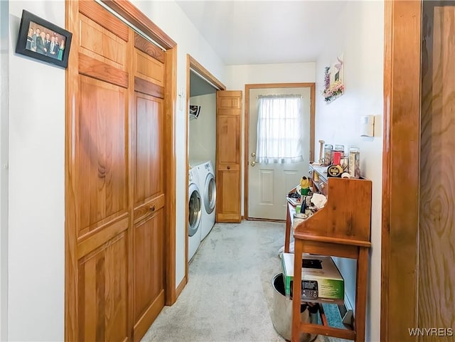 laundry room featuring light carpet and washer and dryer