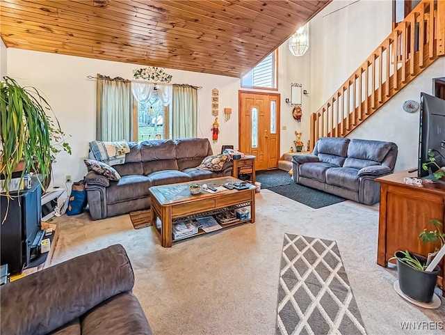 carpeted living room with stairway, wooden ceiling, and high vaulted ceiling