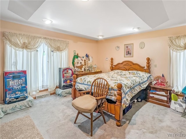 bedroom featuring visible vents, multiple windows, and carpet