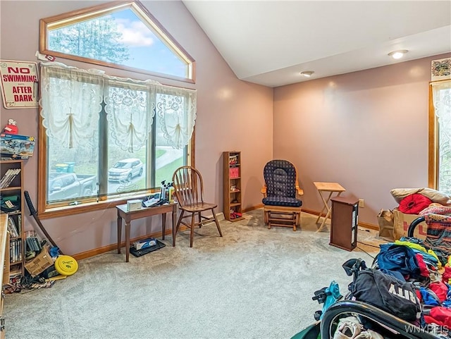 interior space featuring carpet flooring, baseboards, and vaulted ceiling