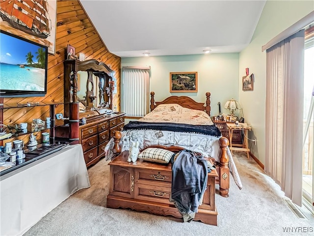 bedroom with carpet floors, wood walls, and visible vents