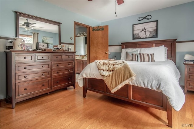 bedroom featuring ceiling fan, connected bathroom, and light wood-style flooring