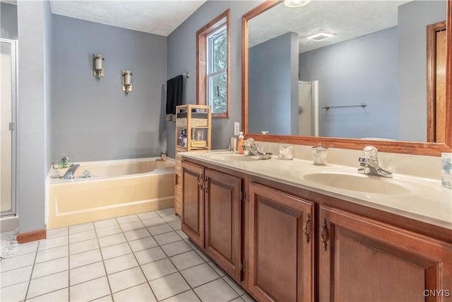 full bathroom featuring a stall shower, a garden tub, and a sink