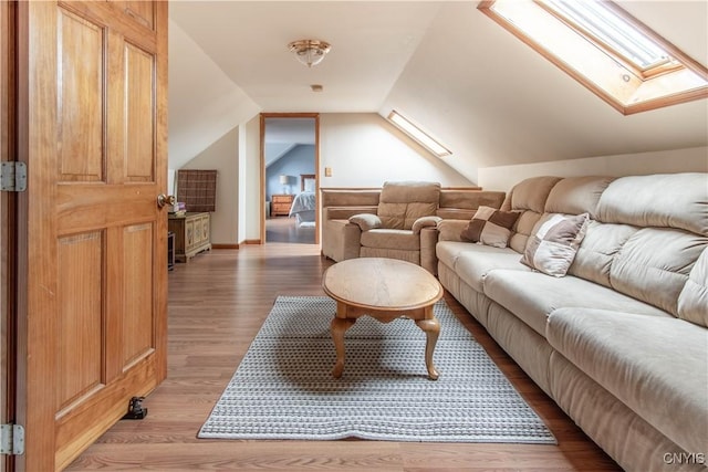 interior space with lofted ceiling with skylight and light wood-style floors