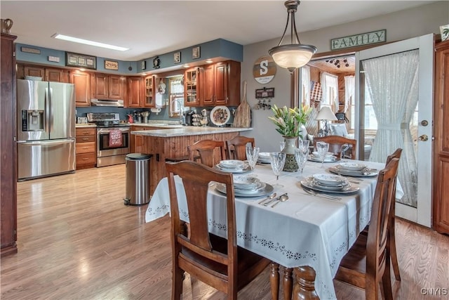 dining area with light wood-style flooring