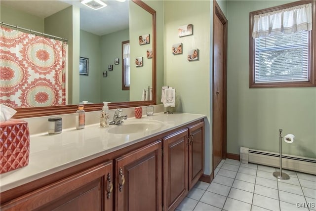 bathroom with visible vents, baseboard heating, baseboards, tile patterned floors, and vanity