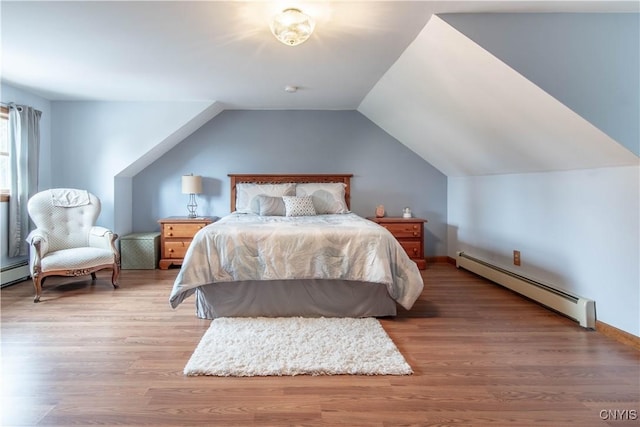 bedroom featuring baseboards, vaulted ceiling, wood finished floors, and a baseboard radiator