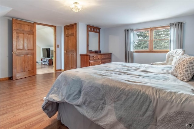 bedroom featuring baseboards and light wood-style flooring