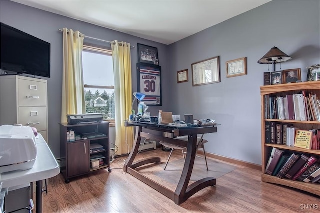 office space with wood finished floors and baseboards
