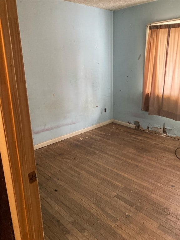 5125 Deliverance Ave, Williamson, NY 14505 - spare room featuring baseboards, hardwood / wood-style floors, and a textured ceiling