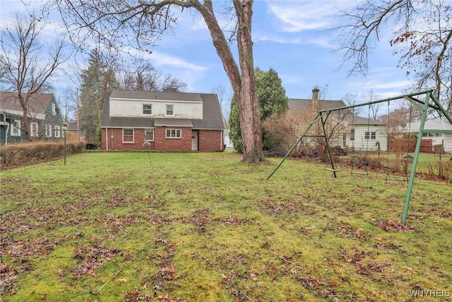 339 Lincoln Ave, Lockport-City, NY 14094 - rear view of property with brick siding, fence, and a lawn