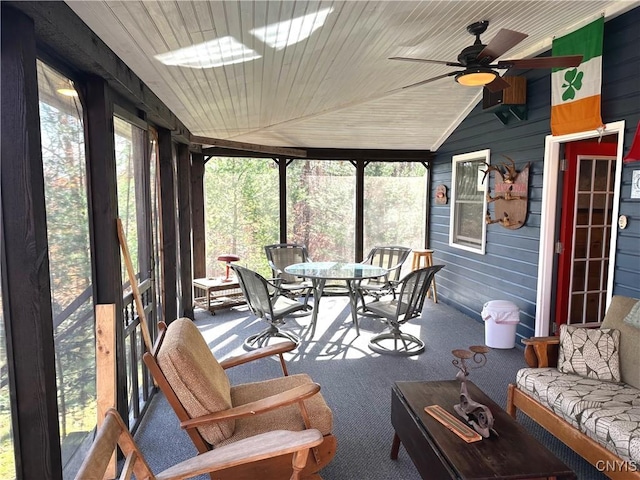 sunroom / solarium featuring outdoor dining area and ceiling fan
