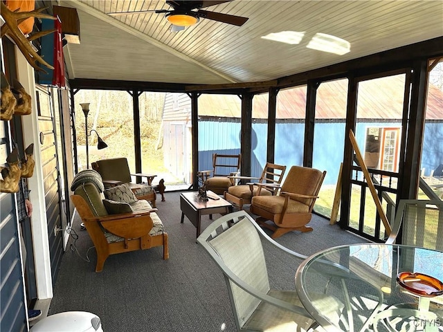 sunroom featuring outdoor dining space, carpet, outdoor lounge area, and ceiling fan