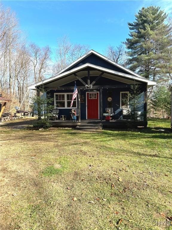 view of front of home featuring a front yard and a porch