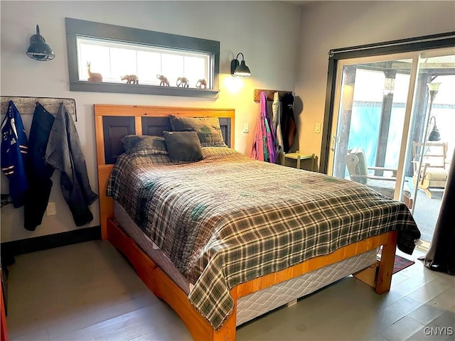 bedroom featuring access to outside and wood finished floors