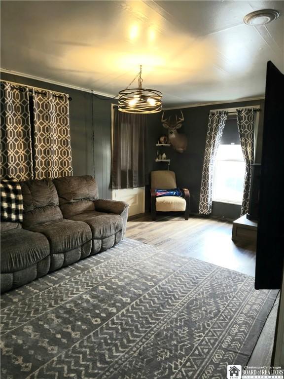 787 State Route 417, Andover, NY 14806 - living area with an inviting chandelier, ornamental molding, and wood finished floors