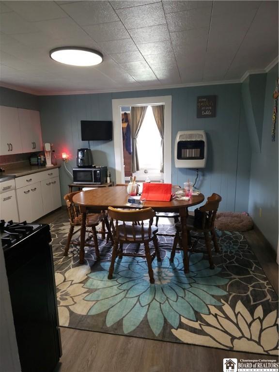 787 State Route 417, Andover, NY 14806 - dining room with wood finished floors, ornamental molding, and heating unit