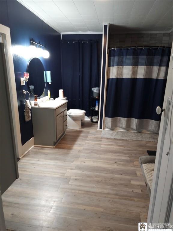 787 State Route 417, Andover, NY 14806 - bathroom with toilet, a shower with shower curtain, vanity, and wood finished floors