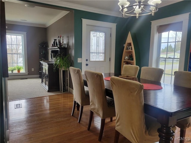 165 Howe St, Le Ray, NY 13612 - dining space featuring a chandelier, crown molding, wood finished floors, and baseboards