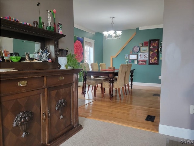 165 Howe St, Le Ray, NY 13612 - dining area featuring crown molding, a chandelier, baseboards, and light wood-style flooring