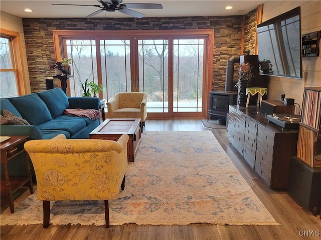 165 Howe St, Le Ray, NY 13612 - living area featuring a wood stove, ceiling fan, and wood finished floors
