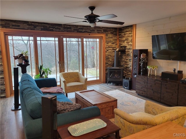 165 Howe St, Le Ray, NY 13612 - living area with a ceiling fan, light wood-type flooring, and a wood stove