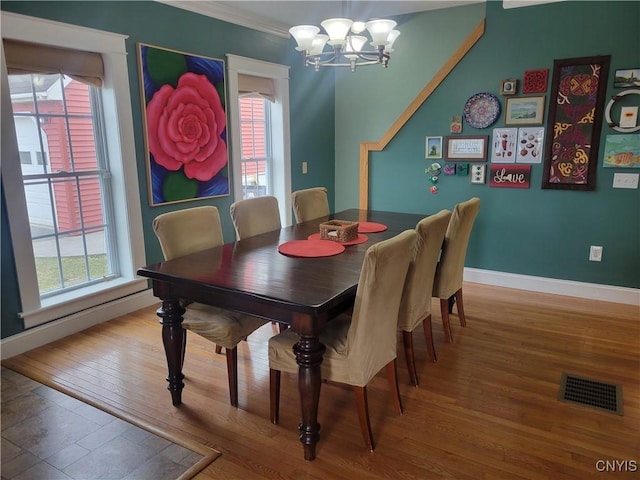 165 Howe St, Le Ray, NY 13612 - dining space with a chandelier, wood finished floors, baseboards, and crown molding