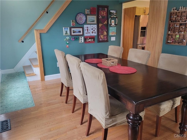 165 Howe St, Le Ray, NY 13612 - dining room with light wood finished floors, stairs, and baseboards