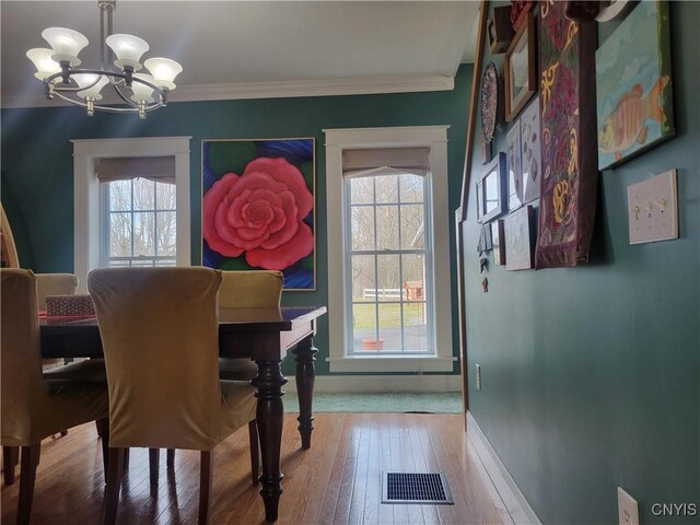 165 Howe St, Le Ray, NY 13612 - dining room with a chandelier, light wood-style flooring, baseboards, and ornamental molding