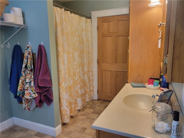 165 Howe St, Le Ray, NY 13612 - bathroom featuring vanity, a shower with curtain, and baseboards