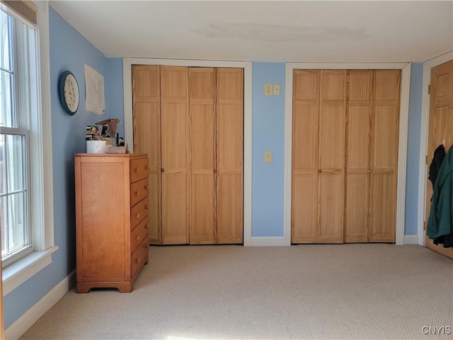165 Howe St, Le Ray, NY 13612 - bedroom featuring multiple closets, light carpet, and baseboards