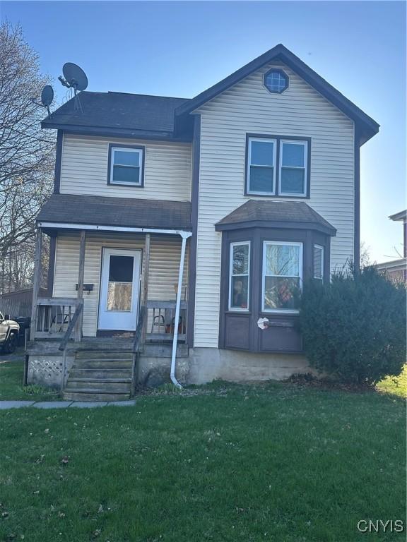 918 Midland Ave, Syracuse, NY 13205 - traditional home featuring a shingled roof, a porch, and a front lawn