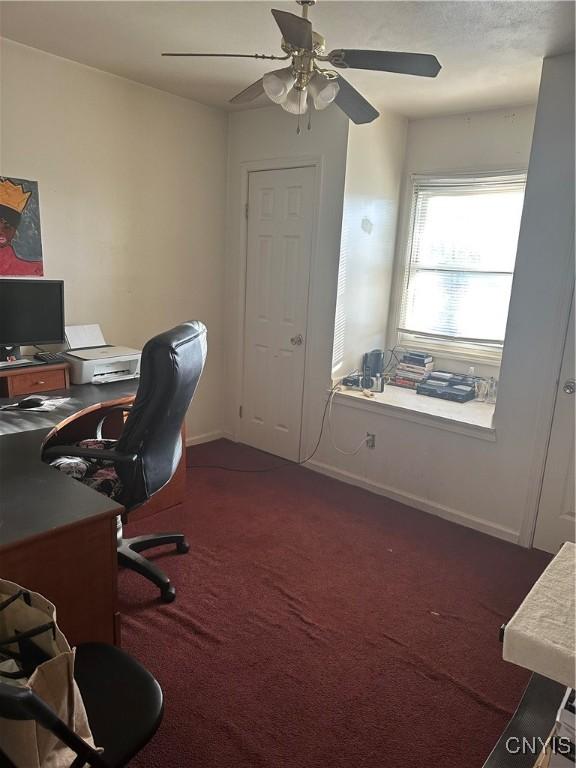 918 Midland Ave, Syracuse, NY 13205 - home office featuring ceiling fan, dark colored carpet, and baseboards