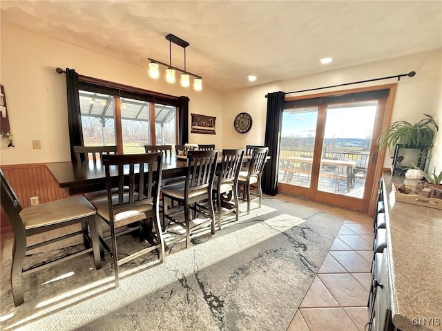 dining area with light tile patterned flooring, wainscoting, and recessed lighting