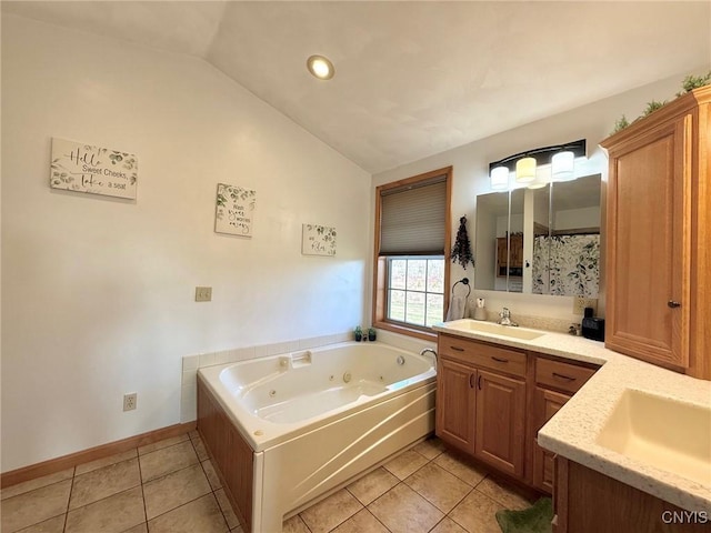 full bathroom featuring a whirlpool tub, vanity, baseboards, vaulted ceiling, and tile patterned flooring