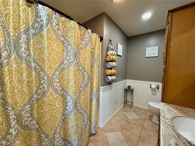 full bathroom with vanity, tile patterned flooring, recessed lighting, toilet, and wainscoting
