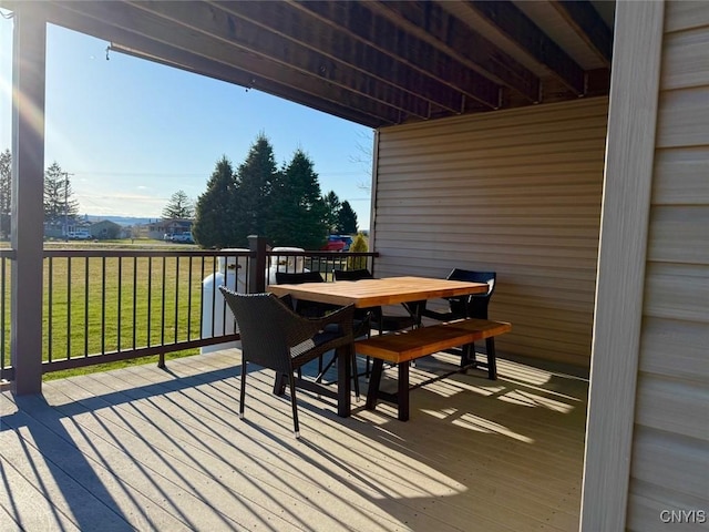 deck featuring a yard and outdoor dining space