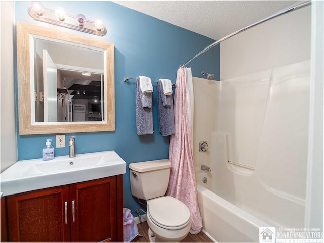 bathroom with shower / bath combo, vanity, a textured ceiling, and toilet