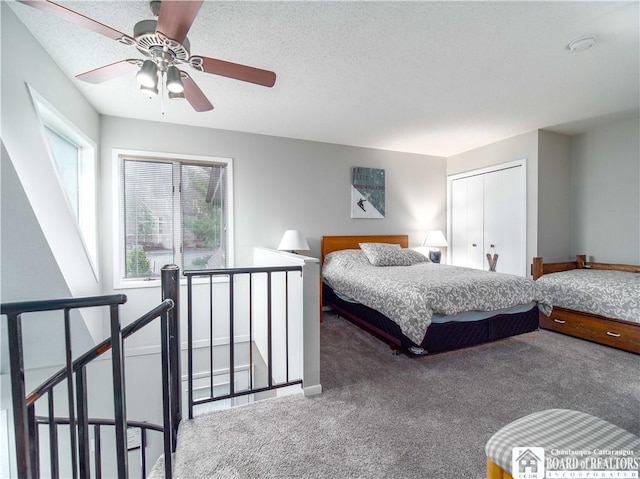 carpeted bedroom with a closet and a ceiling fan