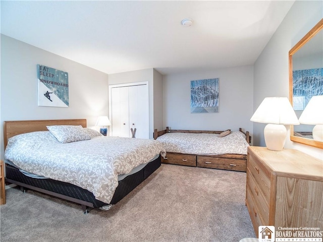 bedroom with carpet and a closet